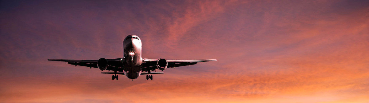 XXL jet airplane landing at sunset