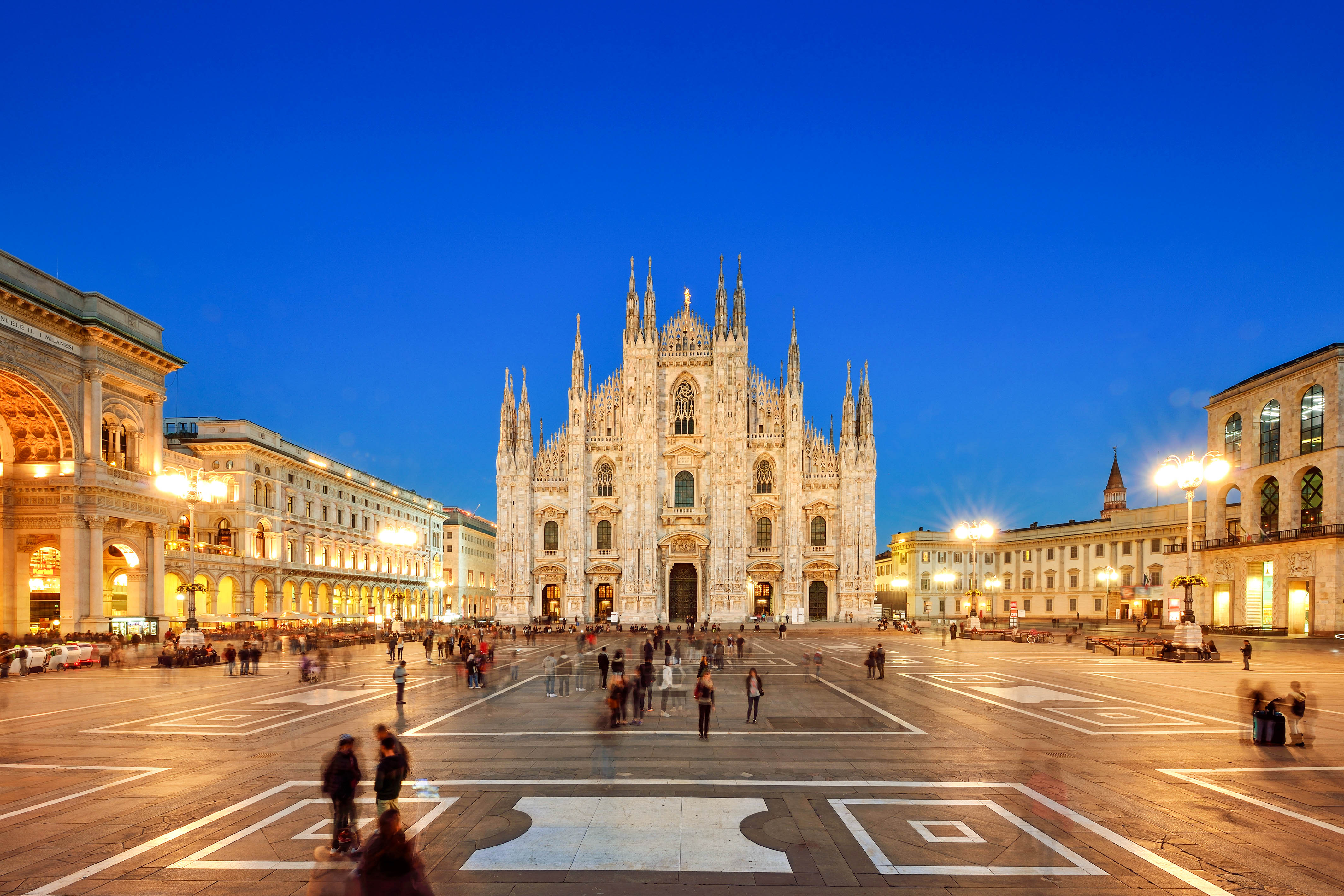Panoramic Milan Piazza Del Duomo and Vittorio Emanuele Gallery II in blue sky at sunset, Milan, Italy.