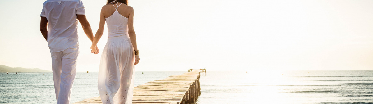 young couple walking on pier